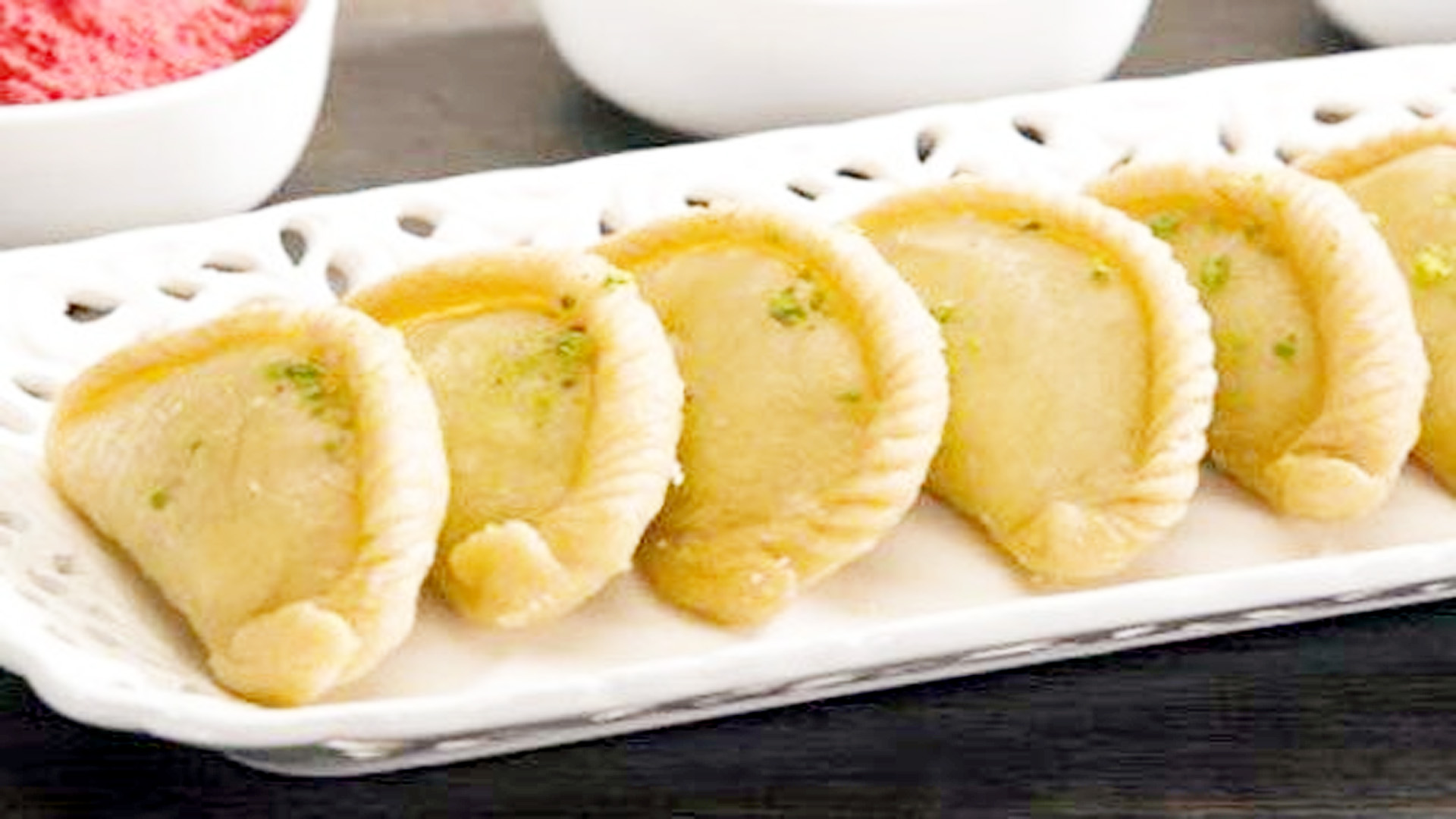 Try traditional snacks of Gujiya and Papad on Holi.