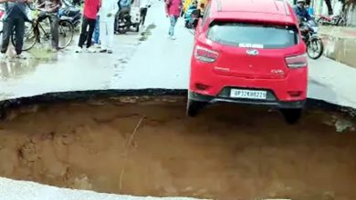 Car stuck in a pit on a road that has sunk due to rain in Lucknow, alert issued