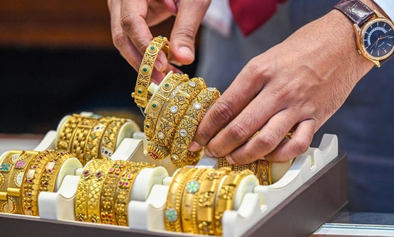 Gold rises, silver slips after record high