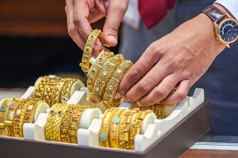 Gold rises, silver slips after record high